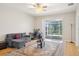 Bright living room with stylish rug, comfortable seating, and sliding glass doors to the outdoor patio at 10260 Devonshire Lake Dr, Tampa, FL 33647