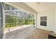 Outdoor screened patio featuring brick flooring, fan, and open view of the outdoor space at 10260 Devonshire Lake Dr, Tampa, FL 33647
