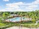 Aerial view of a large community pool with ample seating, landscaping, and water slide at 10260 Devonshire Lake Dr, Tampa, FL 33647