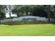 Community entrance sign for Arbor Greene with manicured landscaping and lush green lawn at 10260 Devonshire Lake Dr, Tampa, FL 33647