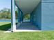 Back porch with pavers and blue columns is ready for your finishing touches at 1033 Hammock Cir, Tarpon Springs, FL 34688