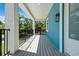 Inviting balcony with outdoor seating and view of mature trees; perfect for relaxing and enjoying the scenery at 1033 Hammock Cir, Tarpon Springs, FL 34688