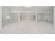 Spacious basement with concrete floor and white support beams is ready for your imagination at 1033 Hammock Cir, Tarpon Springs, FL 34688