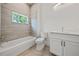 Bathroom with modern vanity, neutral tiling and convenient shower-tub combo at 1033 Hammock Cir, Tarpon Springs, FL 34688