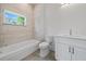 Bathroom features a shower-tub combo, tile accents, and a modern vanity with quartz countertop at 1033 Hammock Cir, Tarpon Springs, FL 34688