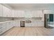 Modern kitchen with stainless steel appliances and white cabinets with sleek hardware at 1033 Hammock Cir, Tarpon Springs, FL 34688
