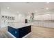 Bright kitchen featuring a navy island, stainless steel appliances, and white cabinets at 1033 Hammock Cir, Tarpon Springs, FL 34688