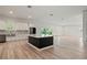 Open floor plan with stainless steel appliances, a blue island and bright lighting at 1033 Hammock Cir, Tarpon Springs, FL 34688