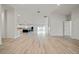 Spacious living room with an open concept to the kitchen and sliding glass doors at 1033 Hammock Cir, Tarpon Springs, FL 34688