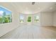 Bright living room features many windows, wood floors, and neutral colors, creating a welcoming space at 1033 Hammock Cir, Tarpon Springs, FL 34688