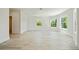 Bright living room with beautiful wood floors and windows overlooking green landscape at 1033 Hammock Cir, Tarpon Springs, FL 34688