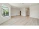 Bright living room with wood floors, recessed lighting, and large window at 1033 Hammock Cir, Tarpon Springs, FL 34688