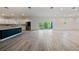 Open floor plan with kitchen, stainless steel appliances, and living room with balcony access at 1033 Hammock Cir, Tarpon Springs, FL 34688