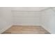 An empty walk-in closet offers storage with hanging wire shelves and wood floor at 1033 Hammock Cir, Tarpon Springs, FL 34688