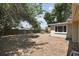 Large backyard with mature trees and a view of the home's exterior, showing ample outdoor space at 10817 Kingsbridge Rd, Port Richey, FL 34668