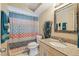 This bathroom features a granite countertop vanity and a shower and bathtub combination at 10817 Kingsbridge Rd, Port Richey, FL 34668