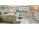 This bright bedroom features natural light from a window and neutral walls and flooring at 10817 Kingsbridge Rd, Port Richey, FL 34668