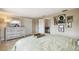 This bedroom has a lot of art on the wall, a white dresser, and neutral walls and flooring at 10817 Kingsbridge Rd, Port Richey, FL 34668