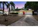Charming single-story home featuring a red front door and well-maintained landscaping at 10817 Kingsbridge Rd, Port Richey, FL 34668