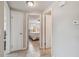 Hallway view featuring neutral walls, tile floors, and open doorways to the interior of the home at 10817 Kingsbridge Rd, Port Richey, FL 34668
