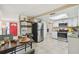 Open kitchen with stainless steel appliances, white cabinets, and an adjacent dining area at 10817 Kingsbridge Rd, Port Richey, FL 34668