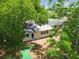 Aerial view of house rear exterior, backyard and privacy fence, with trees in the foreground at 10817 Kingsbridge Rd, Port Richey, FL 34668