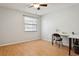 This bedroom has a ceiling fan, natural light, and wood flooring at 11536 Baywood Meadows Dr # 3, New Port Richey, FL 34654