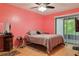 This bedroom features natural light, a ceiling fan, and wood flooring at 11536 Baywood Meadows Dr # 3, New Port Richey, FL 34654