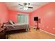The bedroom features natural light, a ceiling fan, and wood flooring at 11536 Baywood Meadows Dr # 3, New Port Richey, FL 34654