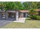 Charming single-story home featuring a covered parking area and lush front yard landscaping at 11536 Baywood Meadows Dr # 3, New Port Richey, FL 34654