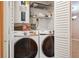 This laundry room has a washer, dryer, and shelving at 11536 Baywood Meadows Dr # 3, New Port Richey, FL 34654