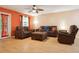 Inviting living room features hardwood floors, modern ceiling fan, and comfortable furniture at 11536 Baywood Meadows Dr # 3, New Port Richey, FL 34654