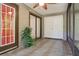 Covered outdoor patio with tile floors, ceiling fan, sliding glass doors and storage at 11536 Baywood Meadows Dr # 3, New Port Richey, FL 34654