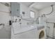 A laundry room with a washing machine, dryer, and a utility sink at 1170 Chelsea Ln, Holiday, FL 34691