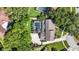 Overhead view of a home with a screened-in pool, lush landscaping, and ample green space, perfect for outdoor living at 11804 Carrollwood Village Cv, Tampa, FL 33618