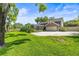 Backyard view highlighting a screened outdoor space and a three-car garage at 11804 Carrollwood Village Cv, Tampa, FL 33618