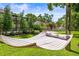 Relaxing hammock in a lush backyard setting with manicured lawn and mature trees at 11804 Carrollwood Village Cv, Tampa, FL 33618