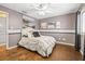 Bedroom with hardwood floors, a queen-sized bed, and decorative wall art at 11804 Carrollwood Village Cv, Tampa, FL 33618
