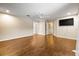 Large bedroom featuring a TV, ceiling fan, hardwood floors, and neutral color scheme at 11804 Carrollwood Village Cv, Tampa, FL 33618