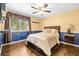 Cozy bedroom featuring wood floors, ample natural light, and a traditional ceiling fan at 11804 Carrollwood Village Cv, Tampa, FL 33618