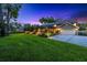 Well-manicured lawn and landscaping surround this lovely home, complete with a screened pool and attached garage at 11804 Carrollwood Village Cv, Tampa, FL 33618
