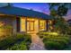 Charming home exterior featuring a brick walkway, decorative front door, and lush landscaping at 11804 Carrollwood Village Cv, Tampa, FL 33618
