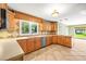 Well-lit kitchen with wooden cabinetry, stainless steel appliances, and an eat-in area at 11804 Carrollwood Village Cv, Tampa, FL 33618