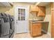 Convenient laundry room offers a utility sink, storage cabinets, and exterior access at 11804 Carrollwood Village Cv, Tampa, FL 33618
