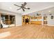 Expansive entertainment room featuring hardwood floors and direct access to a screened outdoor space at 11804 Carrollwood Village Cv, Tampa, FL 33618