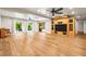 Spacious living room with hardwood floors, large windows, and sliding doors to the pool at 11804 Carrollwood Village Cv, Tampa, FL 33618