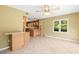 Open floor plan with tile flooring connecting the living room to the kitchen with wooden cabinets at 11804 Carrollwood Village Cv, Tampa, FL 33618