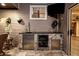 This outdoor kitchen features a beverage fridge, sink, tap, and stone accents at 11804 Carrollwood Village Cv, Tampa, FL 33618