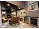 Covered patio features a fireplace, ceiling fan, and an outdoor kitchen with a beverage fridge at 11804 Carrollwood Village Cv, Tampa, FL 33618