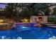 A beautiful in-ground pool features fire bowls, custom tile, and an outdoor pizza oven at 11804 Carrollwood Village Cv, Tampa, FL 33618